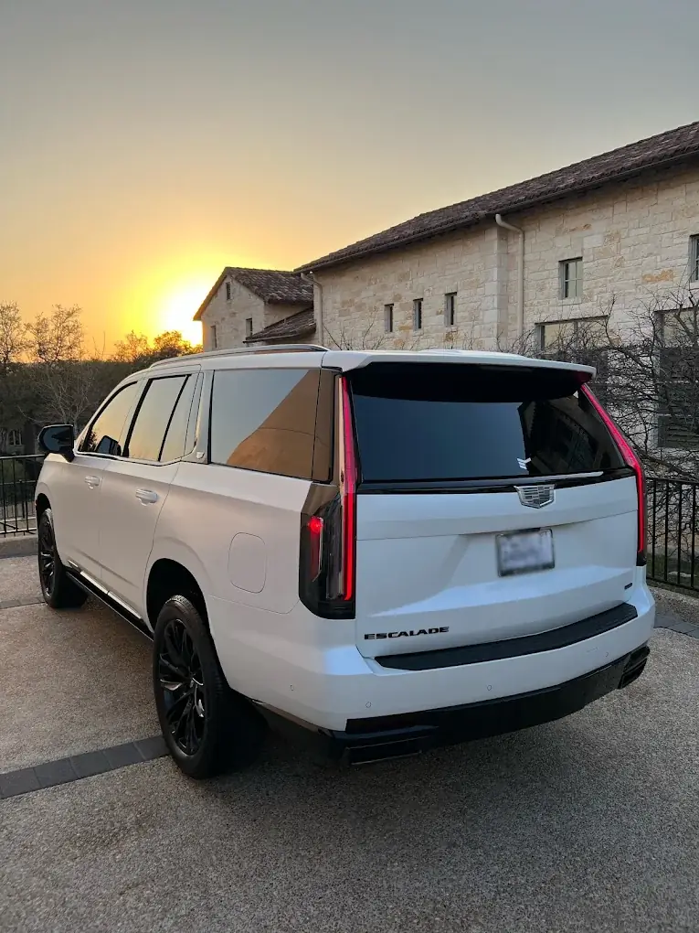 White Cadillac Escalade finished in paint protection film against an evening sky
