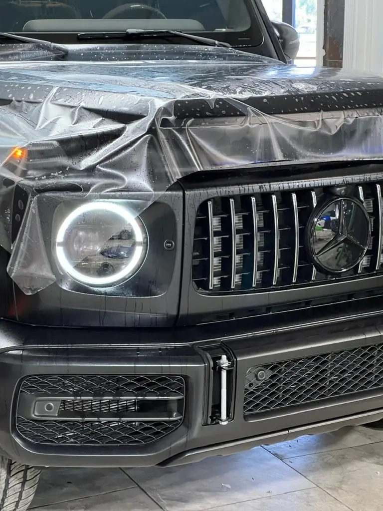 Paint protection film being applied to the front end of a G Wagon in the Boerne shop