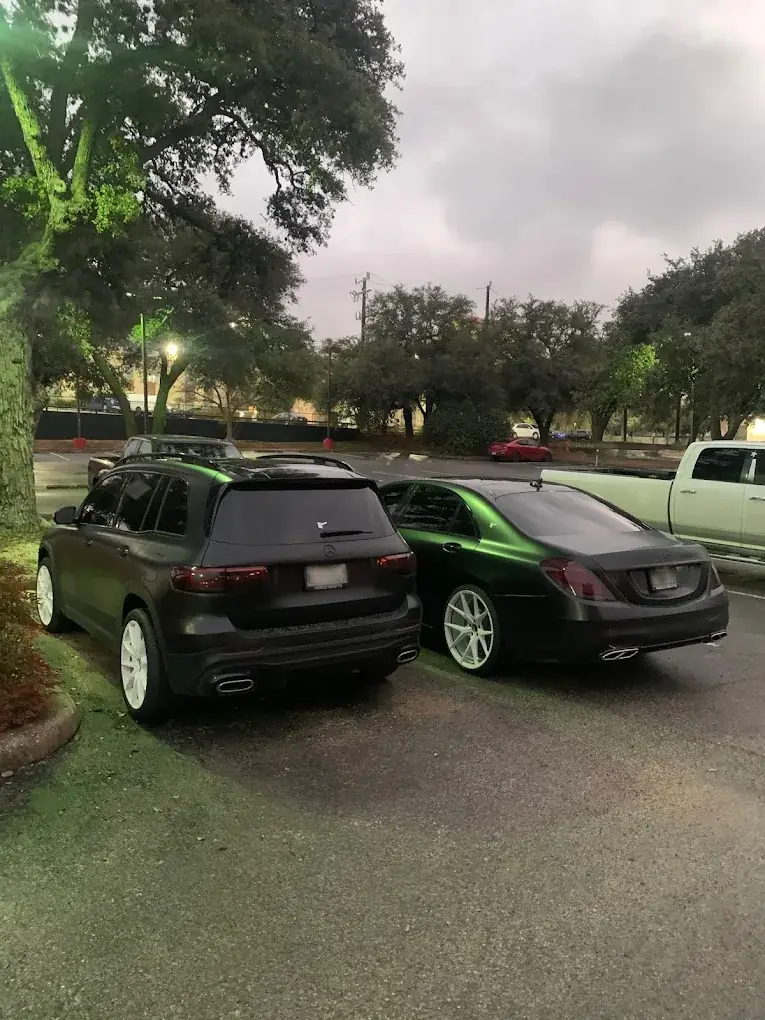 Two matching satin black Mercedes at dusk